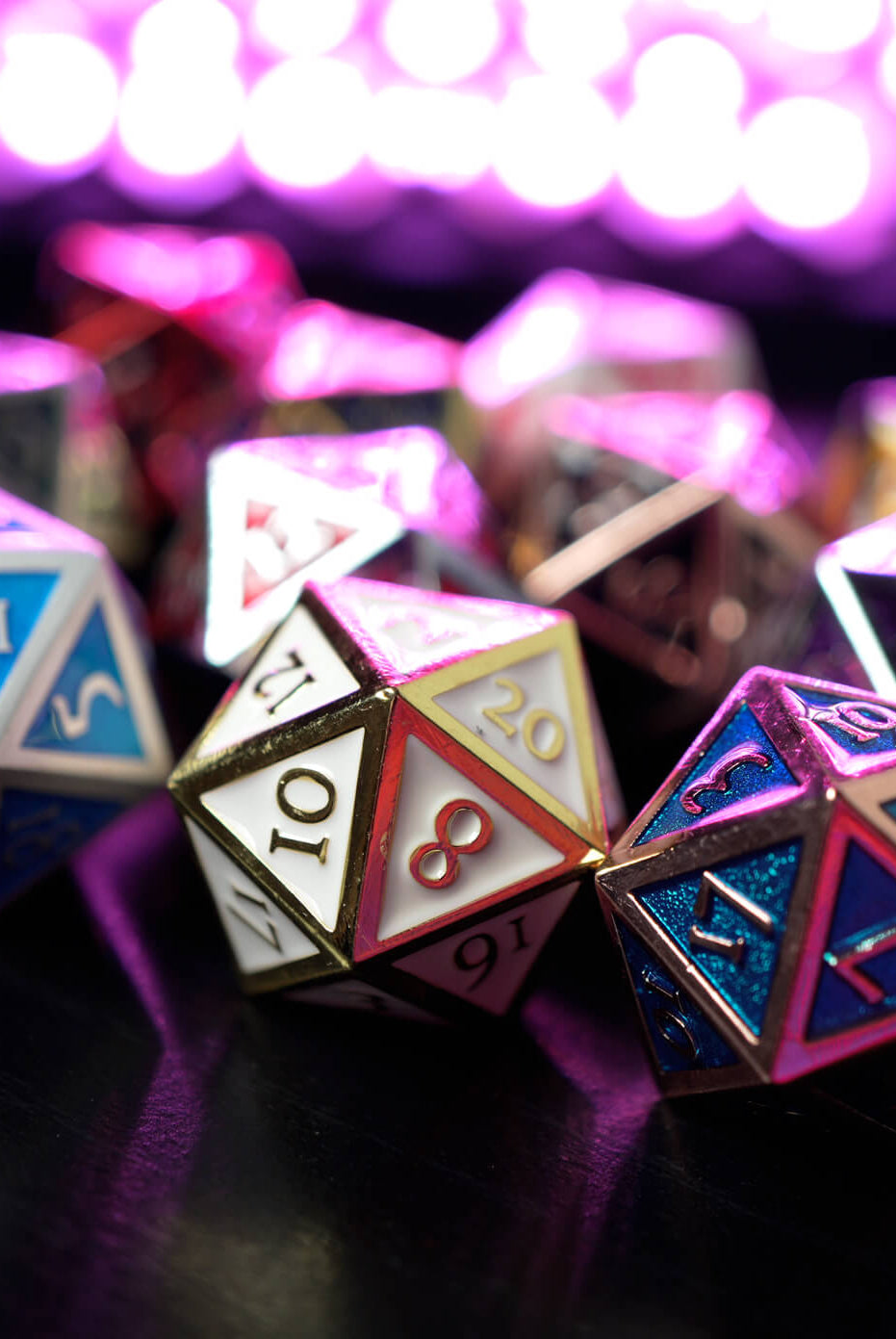metal d20 dice on Dark Elf Dice pictured in front of a glowing purple light
