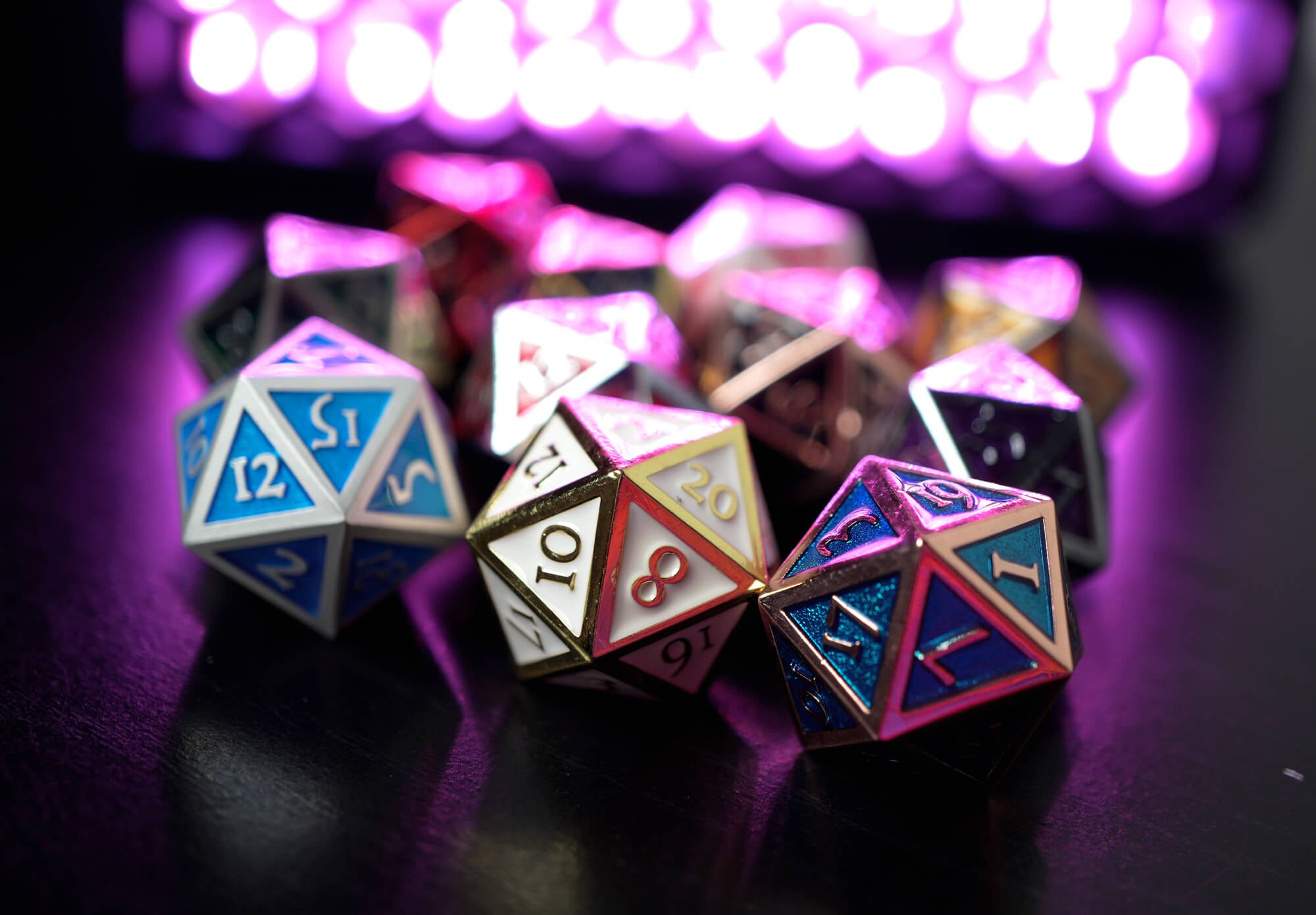 metal d20 dice on Dark Elf Dice pictured in front of a glowing purple light