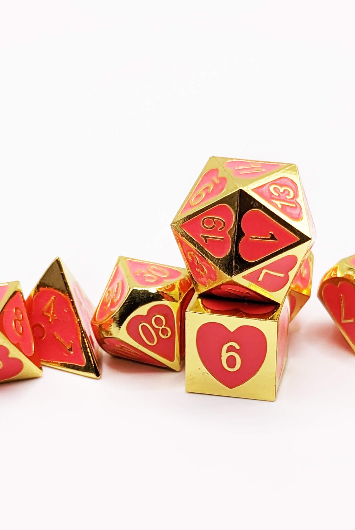 Hot pink and gold metal dice for dnd games