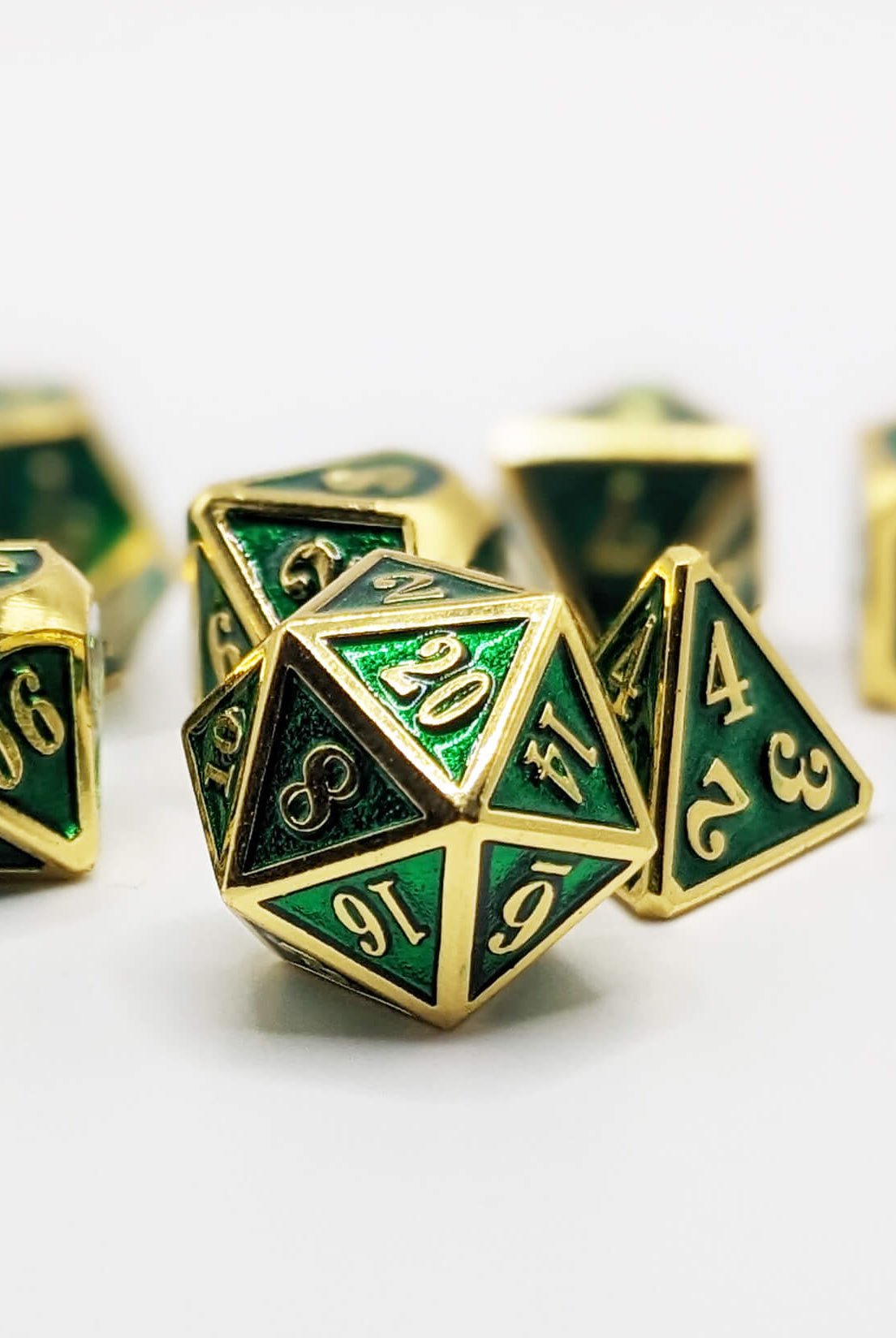 Emerald green and gold metal dice for dnd games