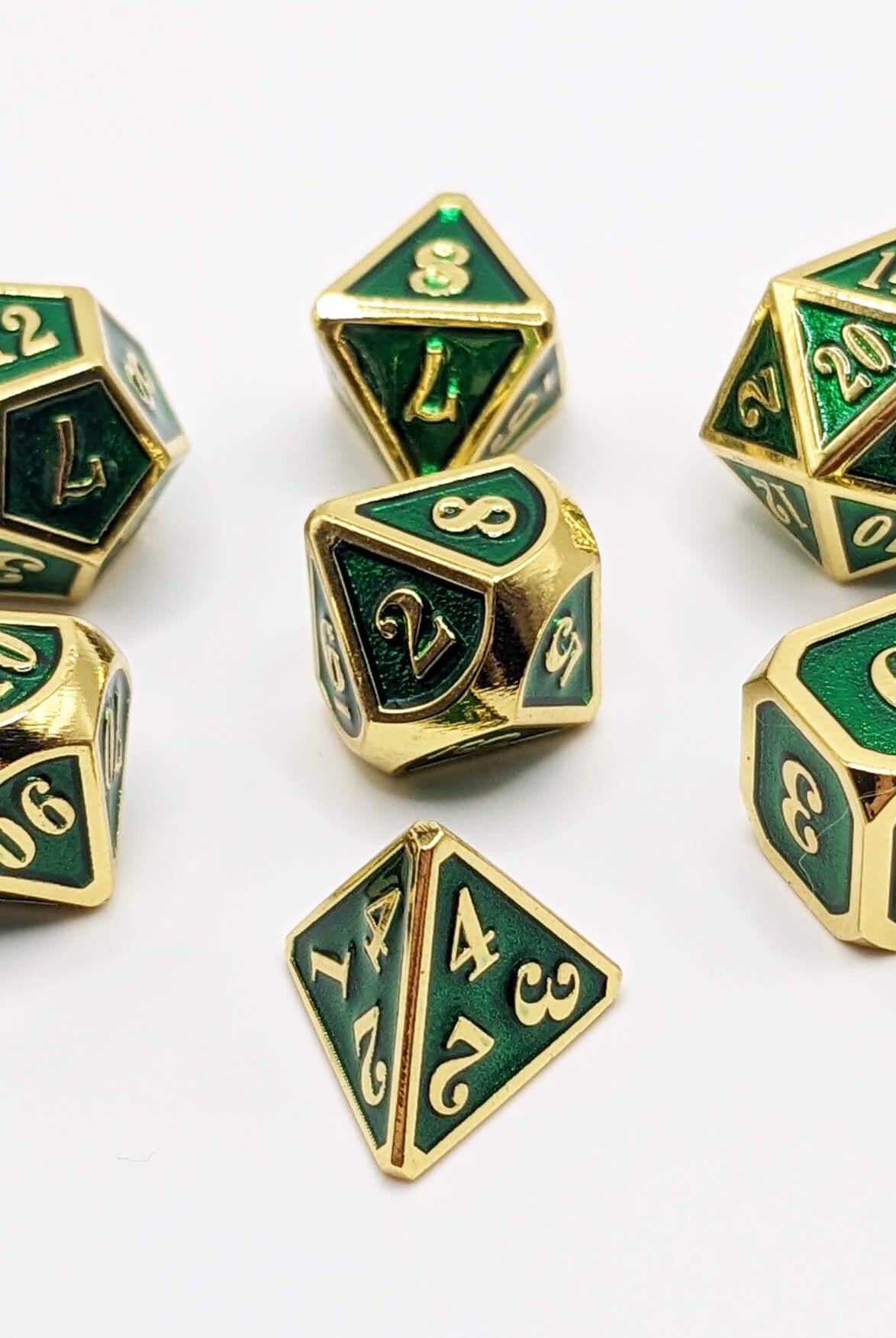 ttrpg gold and green metal dice for games