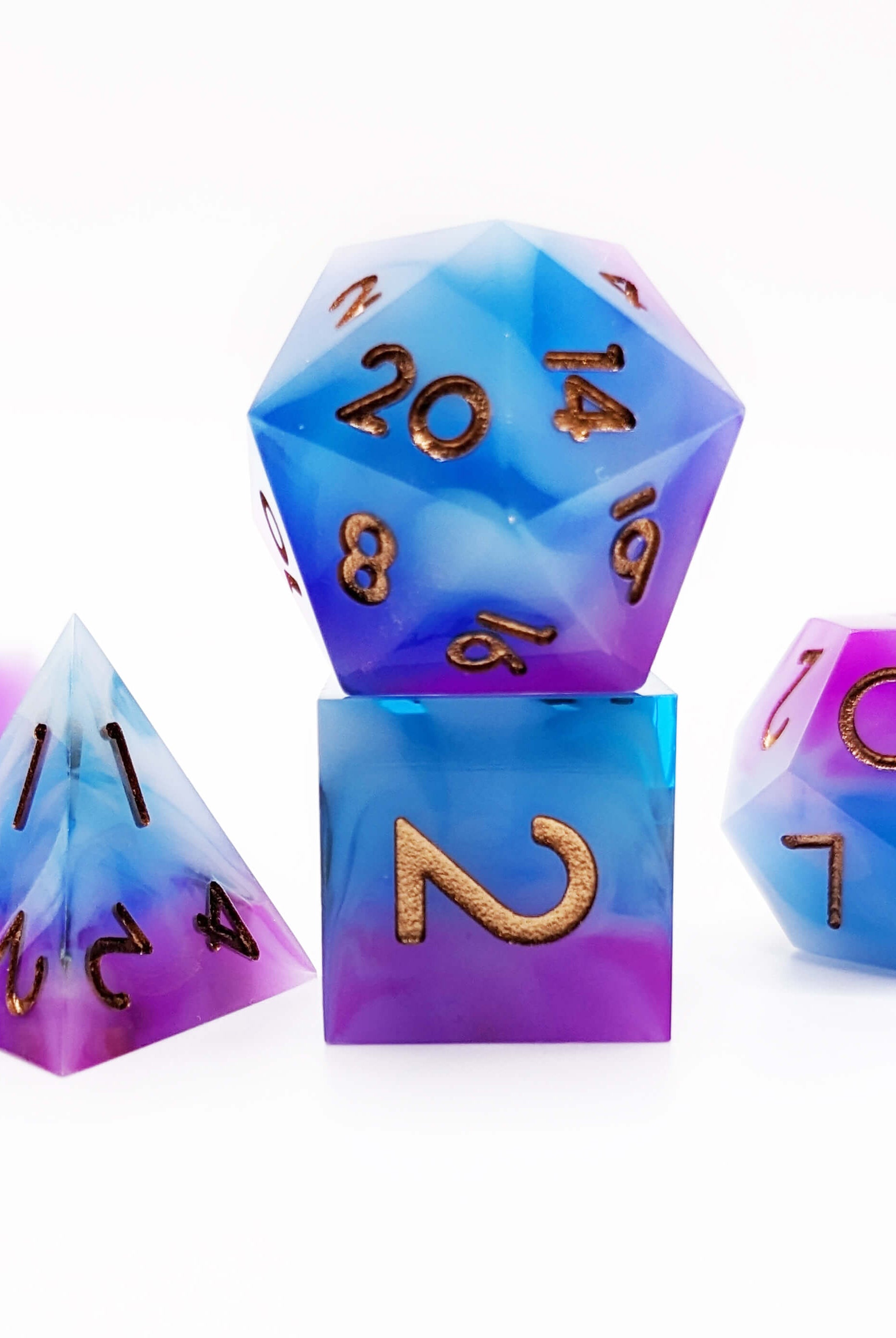 Blue and purple d20 dice