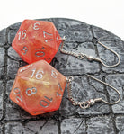 Iridescent Orange d20 earrings on display