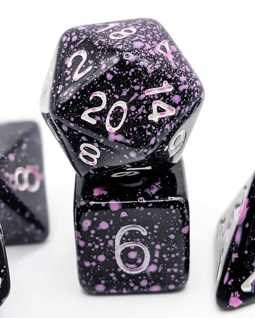 Black dice with purple splatters