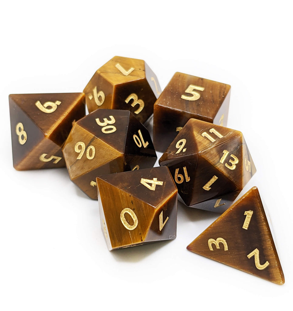 Stone tigers eye dice with gold numbers
